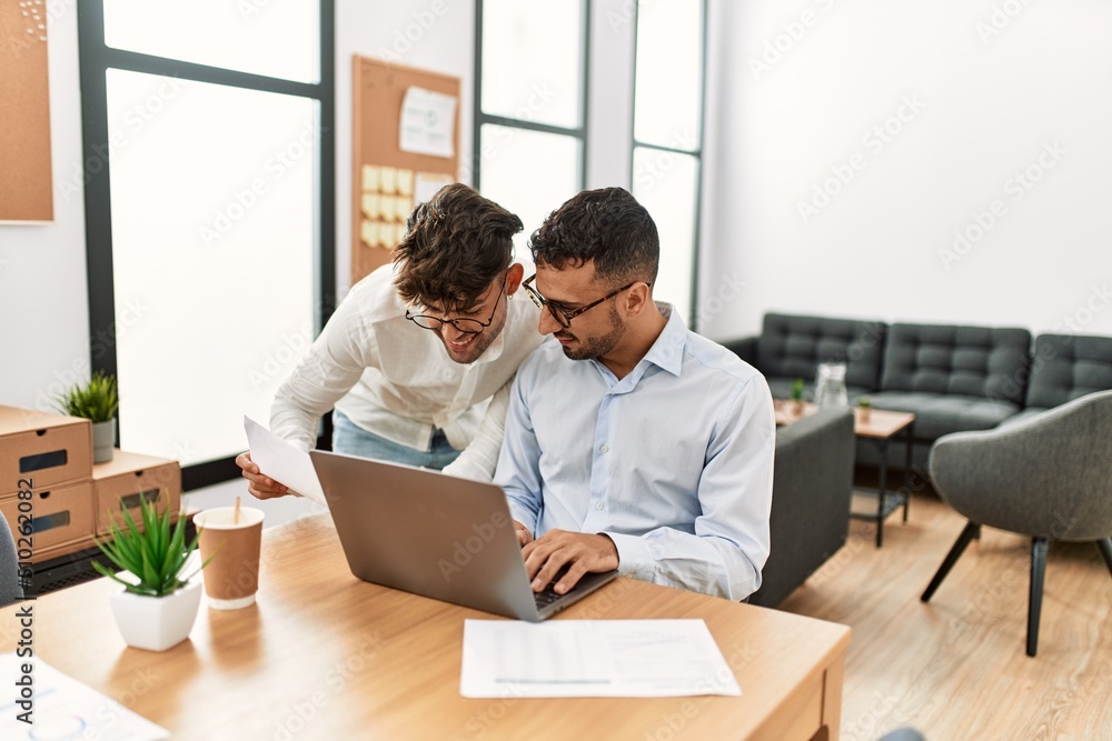 Two hispanic men business workers smiling confident working at office Two hispanic men business workers smiling confident working at office