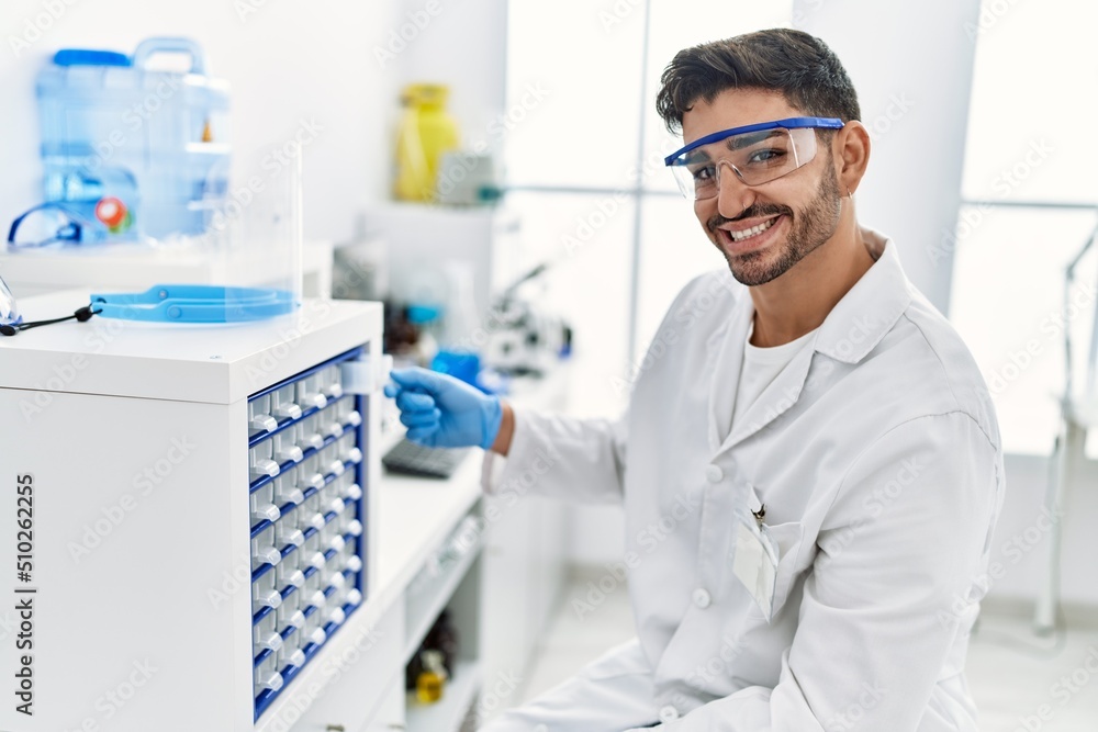 Handsome hispanic man working as scientific at laboratory Handsome hispanic man working as scientific at laboratory