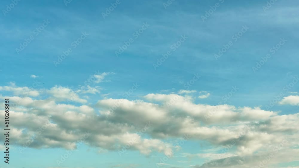 Beautiful white fluffy clouds slowly float against the blue sky on a warm sunny summer day. Timelapse video of cloud movement high quality 4k. Beautiful white fluffy clouds slowly float against the blue sky on a warm sunny summer day. Timelapse video of cloud movement high quality 4k.