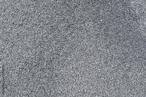 Abstract stone texture. Fine gray gravel. Small gray stones. Building material. Panoramic photo.