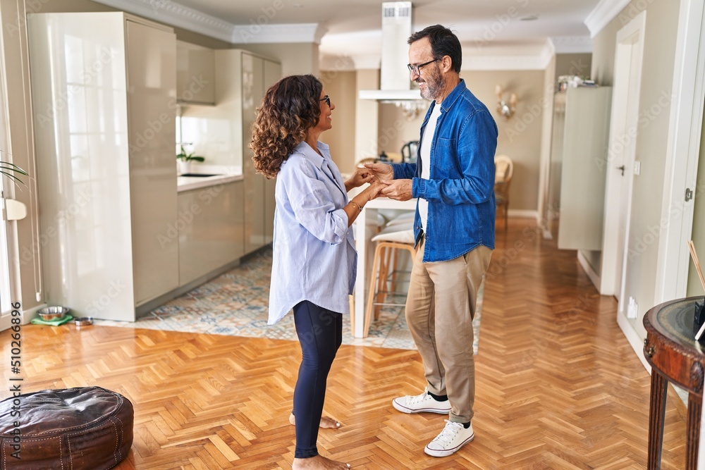 Middle age hispanic couple smiling confident dancing at home Middle age hispanic couple smiling confident dancing at home