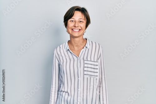 Young caucasian woman wearing casual clothes looking positive and happy standing and smiling with a confident smile showing teeth
