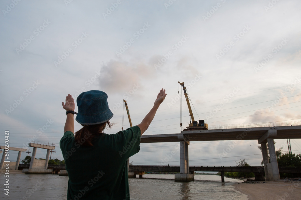 Person giving hand signal to crane Person giving hand signal to crane