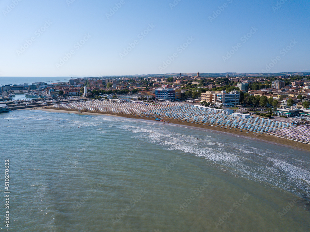 Fototapeta premium Italy, June 2022; aerial view of Fano with its sea, beaches, port, umbrellas