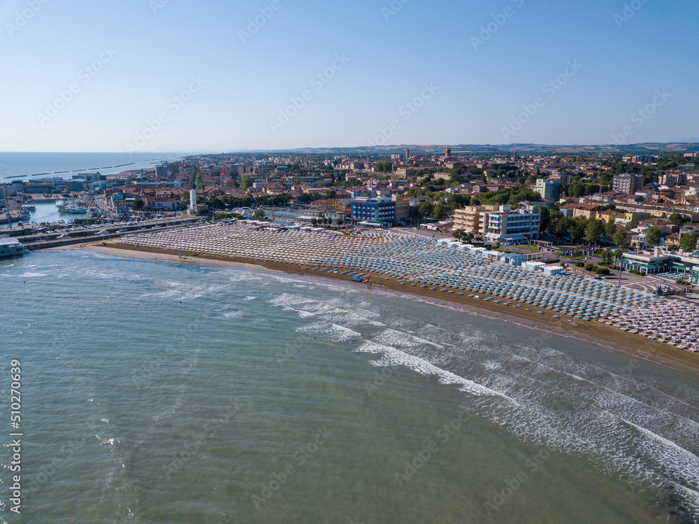 Italy, June 2022; aerial view of Fano with its sea, beaches, port, umbrellas in the marche region