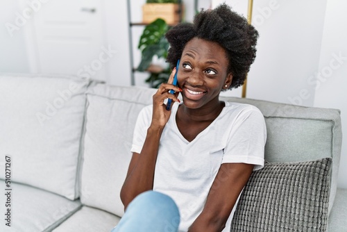 Young african american woman smiling confident speaking on the phone at home