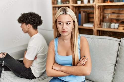 Young couple angry sitting on the sofa in silence at home.