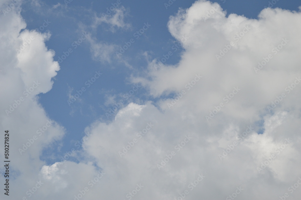 Large puffy white clouds on clear blue sky Large puffy white clouds on clear blue sky