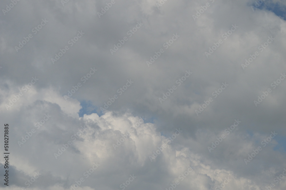 Large puffy white clouds on clear blue sky	