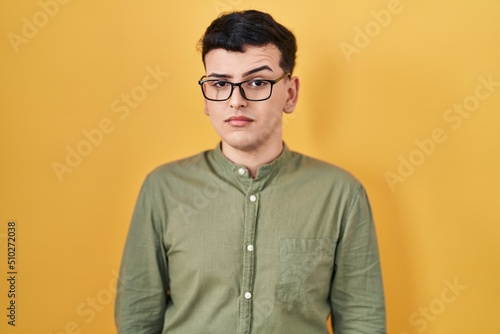 Non binary person standing over yellow background skeptic and nervous, frowning upset because of problem. negative person. © Krakenimages.com