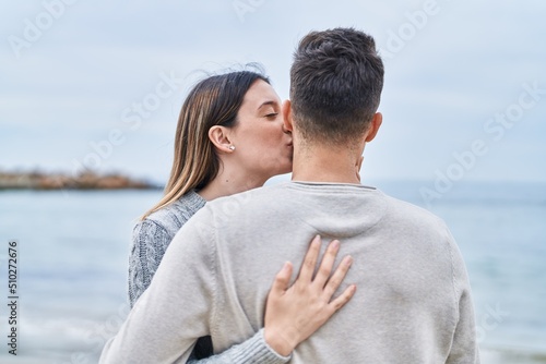 Man and woman couple hugging each other on back view at seaside © Krakenimages.com