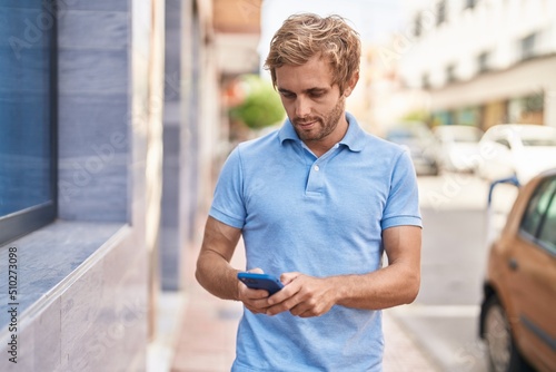 Young man using smartphone at street