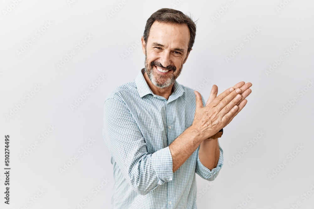 Middle age hispanic man with beard standing over isolated background clapping and applauding happy and joyful, smiling proud hands together Middle age hispanic man with beard standing over isolated background clapping and applauding happy and joyful, smiling proud hands together