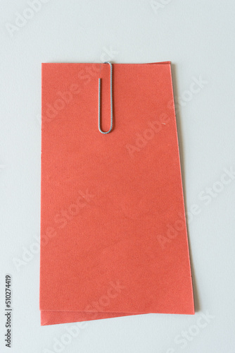 orange paper with metal paper clip