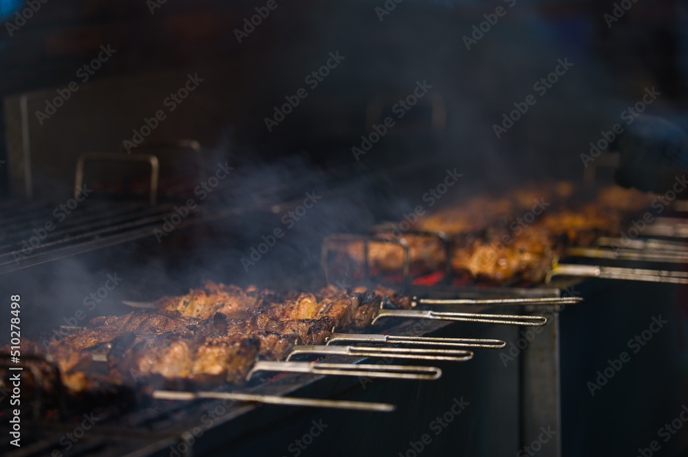 Roasted and grilled chicken skewer with sticks on BBQ in-house plate at restaurant in Philippines Roasted and grilled chicken skewer with sticks on BBQ in-house plate at restaurant in Philippines