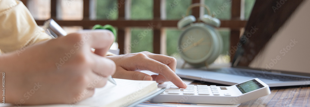 Head of accounting is recording the company's financial growth statistics using graphs as a reference for reviewing and analyzing the results, Taking notes and analyzing data graphs in office. Head of accounting is recording the company's financial growth statistics using graphs as a reference for reviewing and analyzing the results, Taking notes and analyzing data graphs in office.