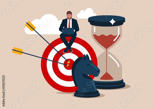 Entrepreneur working with computer sit on target with chess knight and sandglass. Business strategy, planning to achieve goal, management for company growth opportunity, market success goal.