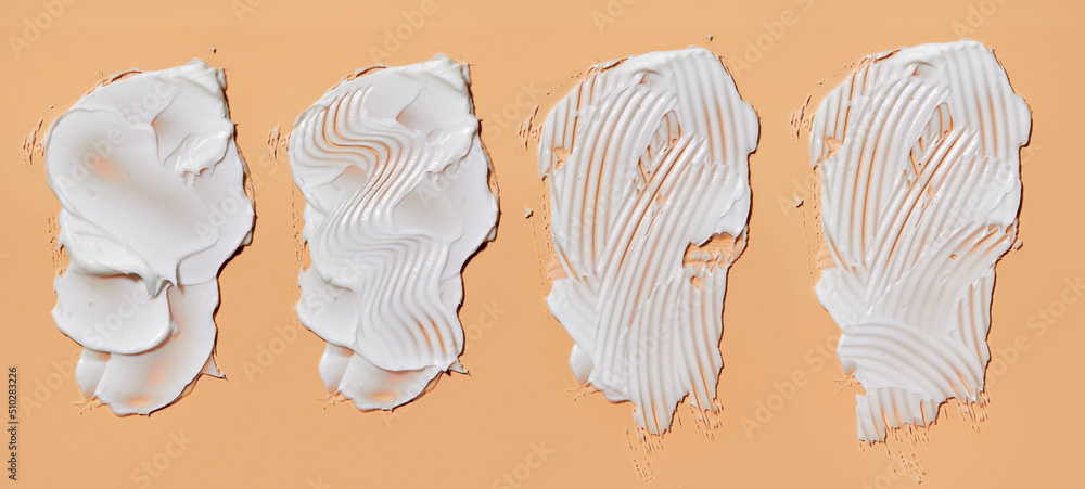 Set with different cosmetic smears on peach background. Beauty creme smear swatch. Cream, Lotion for face or body Set with different cosmetic smears on peach background. Beauty creme smear swatch. Cream, Lotion for face or body