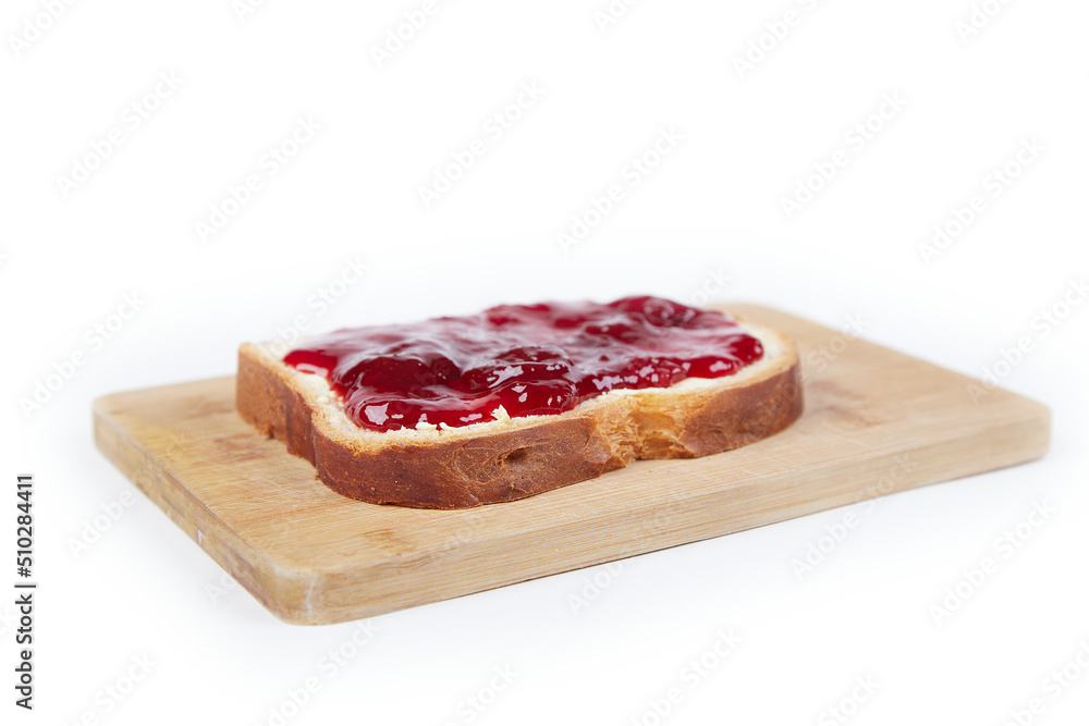 a piece of white bread with strawberry jam, isolated on white background