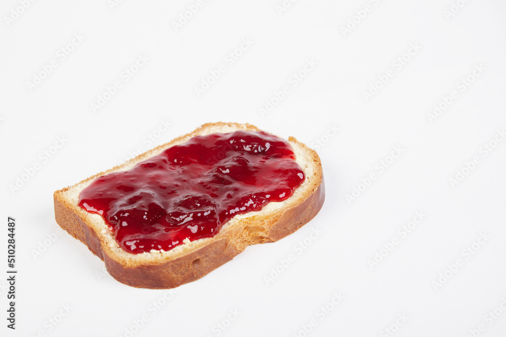 a piece of white bread with strawberry jam, isolated on white background a piece of white bread with strawberry jam, isolated on white background