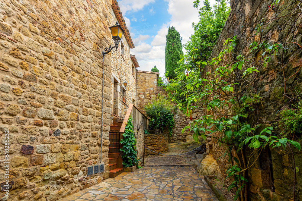 The wet streets of the medieval village of Pals, Spain after a summer rainstorm along the Costa Brava coast of the Catalonian region.