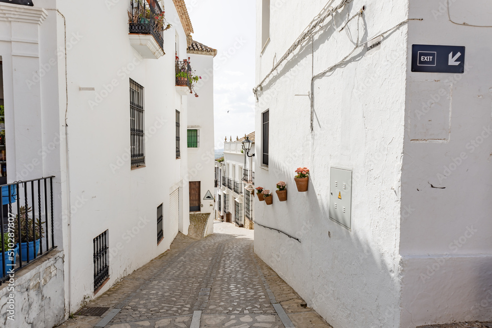 Typical narrow street in Zahara de la Sierra, in Sierra de Grazalema, Cadiz, Andalusia, Spain
