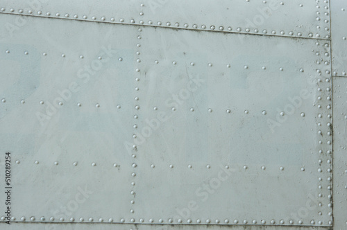 Vintage metal covering. White and blue paint skin with rivet. copy space. Soft focus.