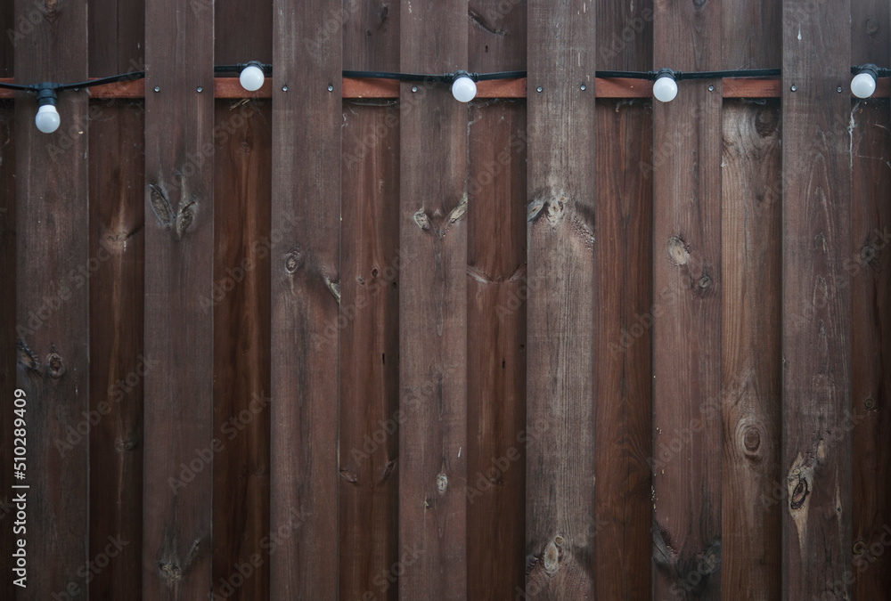 Old plank wooden wall background. The texture of old wood. Weathered piece of wood. Old plank wooden wall background. The texture of old wood. Weathered piece of wood.