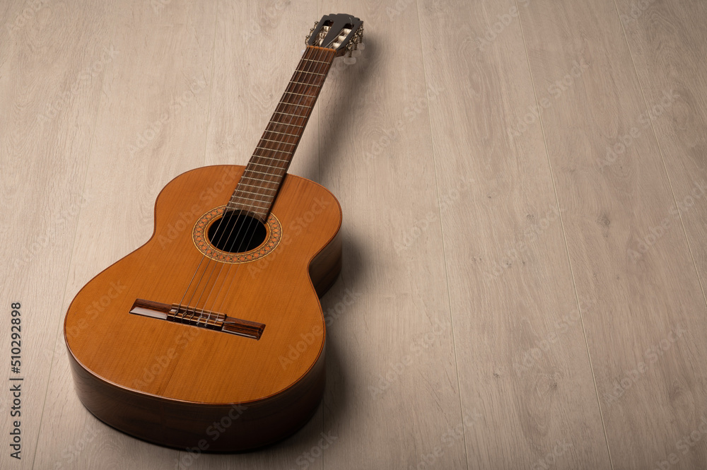 Naklejka premium Classical guitar on a plain background with copy space