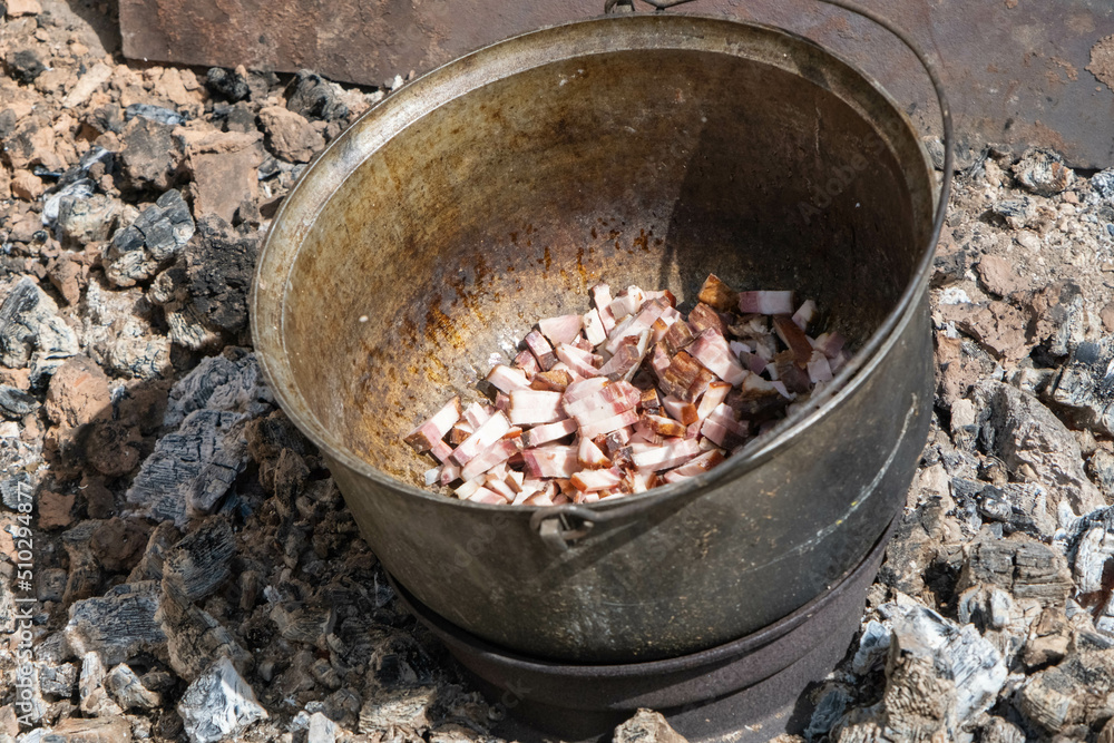 soup cooking process on charcoal. roasting smoked meat in a pot. country kitchen soup cooking process on charcoal. roasting smoked meat in a pot. country kitchen