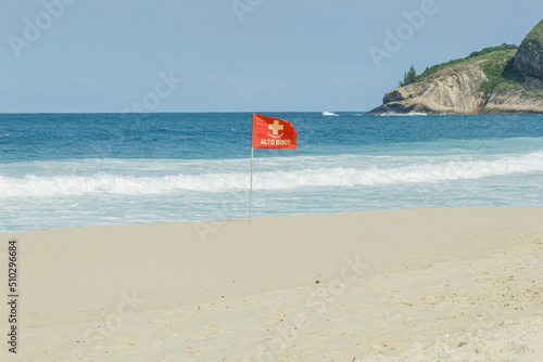 red current signaling flag, written high risk on a beach in Rio de Janeiro, Brazil.