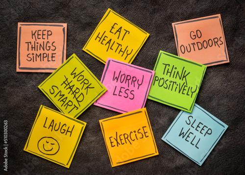 healthy lifestyle and wellbeing concept - a set of inspirational reminder notes against black textured paper photo