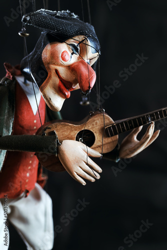 Print op canvas Harlequin puppet doll on strings with selective focus