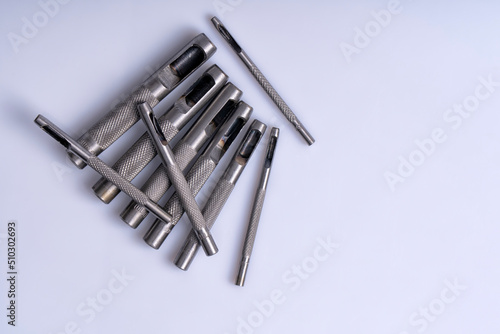 Macro detail of a set of steel punches isolated on white