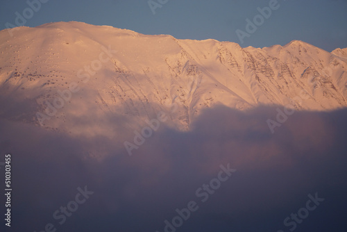 sunset in the  snowy mountains of the southern alps france with fog