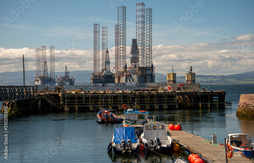 The small boats make the Oil Rigs appear Huge photo