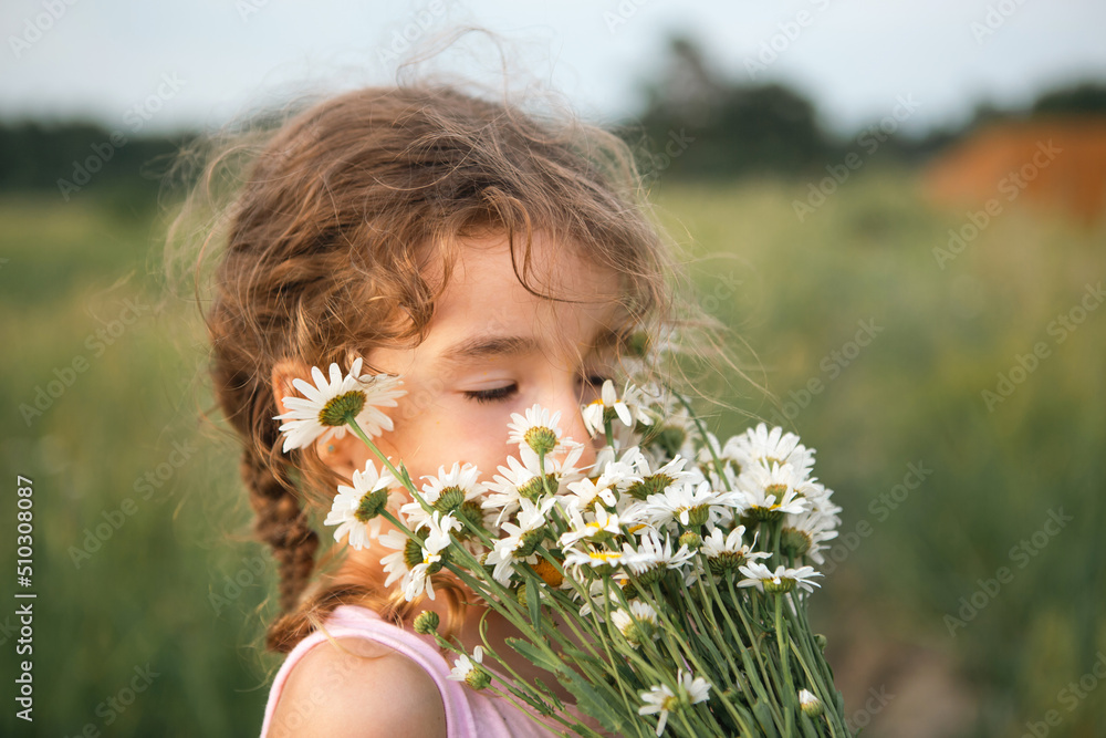 Portrait cute child girl with a bouquet of chamomile in summer on a green natural background. Happy child, hidden face, no face, covered with flowers. Copy space. Authenticity, rural life, eco-friendl Portrait cute child girl with a bouquet of chamomile in summer on a green natural background. Happy child, hidden face, no face, covered with flowers. Copy space. Authenticity, rural life, eco-friendl