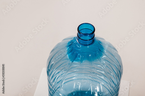 large plastic water bottle. empty bottle neck.