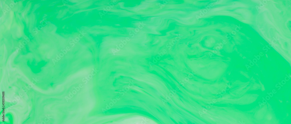 Green Fluid Art Background. Abstract liquid trendy backdrop. Different shades of green on a blurry surface