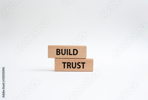 Build trust symbol. Wooden blocks with words Build trust. Beautiful white background. Business and Build trust concept. Copy space.