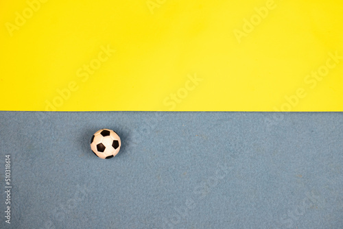 soccer ball on a blue-yellow background photo