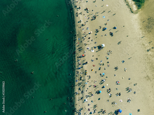 Toronto woodbine beach drone shot with a top view of the beach. The people enjoying summer on the beach. photo