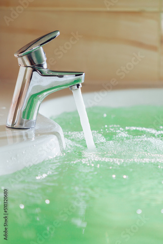 single handle faucet pouring hot water in a bath tub