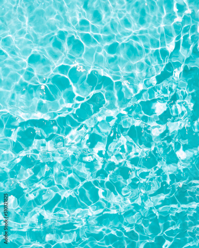Fototapeta Naklejka Na Ścianę i Meble -  Wallpaper made of pool or sea water. Minimal waves concept. Summer, water and sun inspiration.