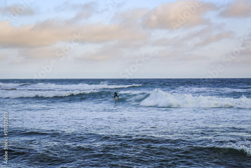 People surfing waves in the Twelve Apostles Marine National Park  Victoria  Australia