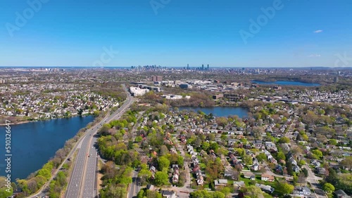 Arlington Heights suburban landscape aerial view in spring with Spy Pond and Boston modern city skyline at the background in historic town of Arlington, Massachusetts MA, USA.  photo