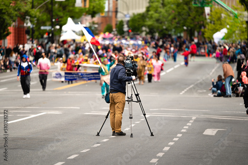 a camera man broadcasting parade photo