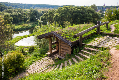 Drinking spring on the slope. Beautiful landscaping in rural style. Rusinovo  Borovsky district  Kaluzhskiy region  Russia