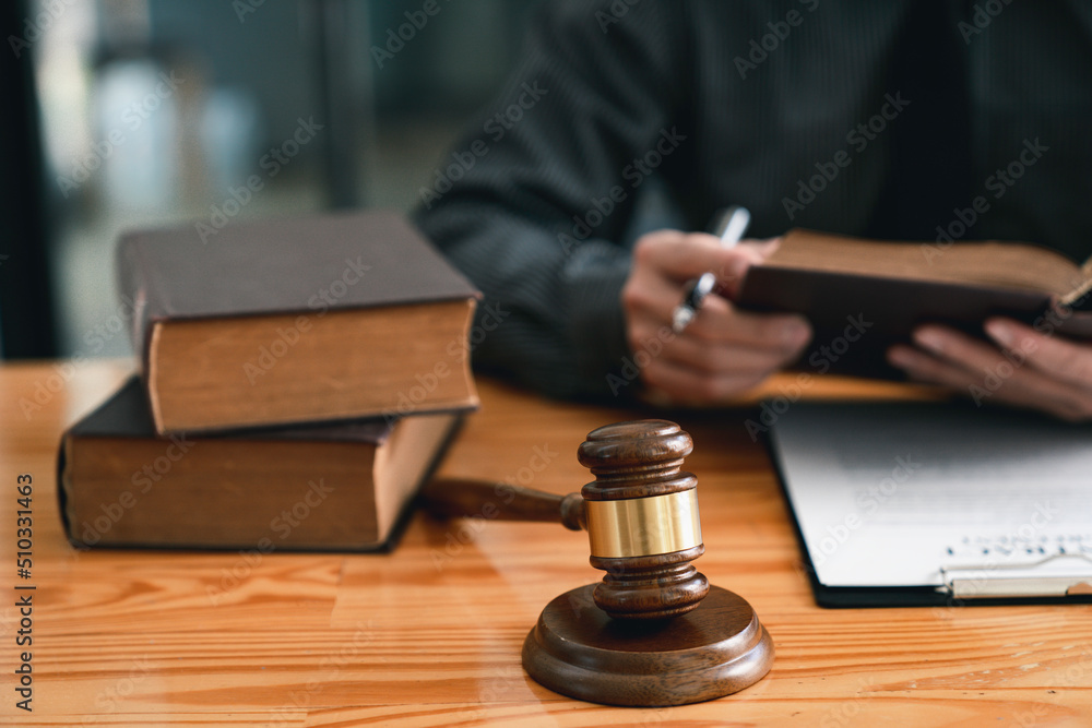 Attorney reading law code, studying constitution to protect human rights closeup, Male lawyer or judge working with Law books, gavel Attorney reading law code, studying constitution to protect human rights closeup, Male lawyer or judge working with Law books, gavel