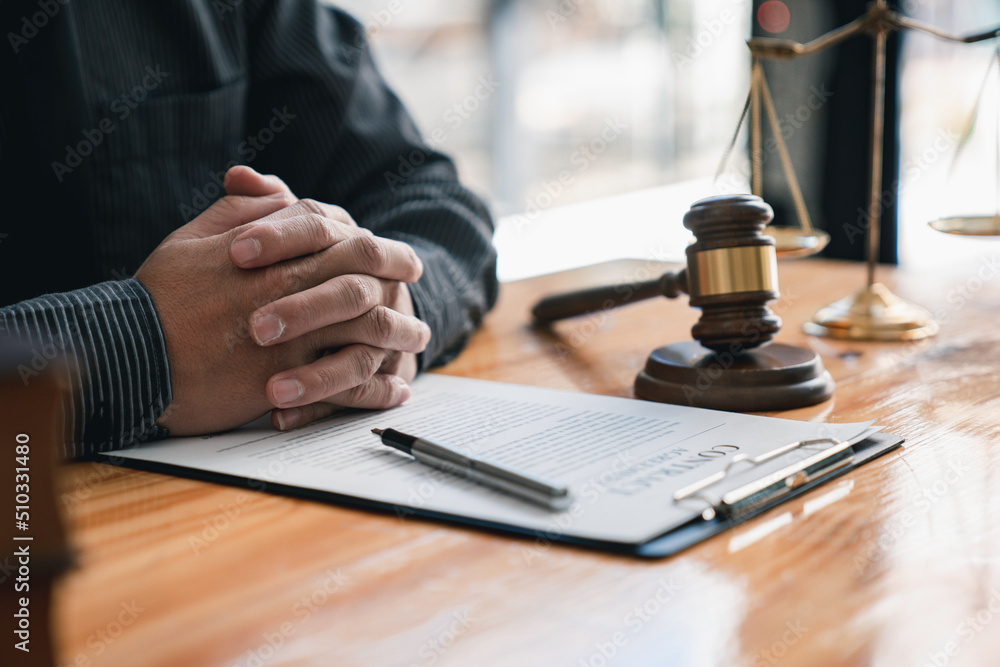 lawyer or judge is giving legal advice. to explaining about consultation terms and conditions to businessmen before signing on contract at a law firm. lawyer or judge is giving legal advice. to explaining about consultation terms and conditions to businessmen before signing on contract at a law firm.